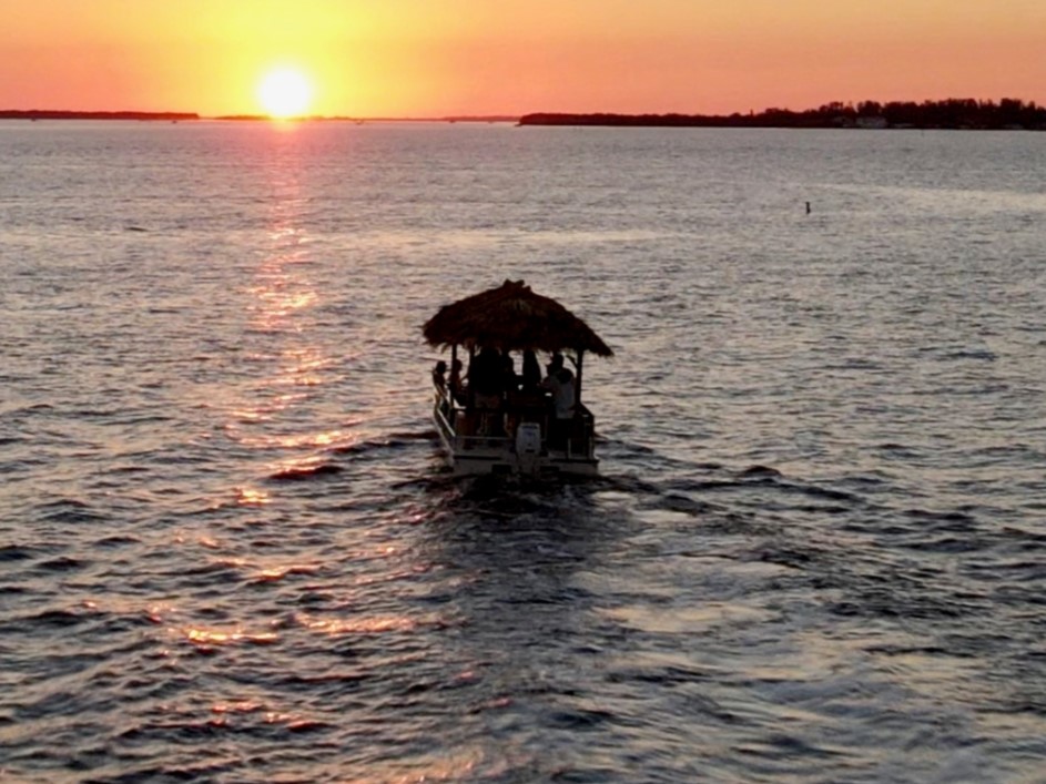 Make memories on your private sunset tiki boat cruise.