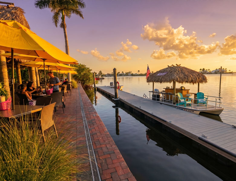 Yucatan Waterfront Restaurant with nautical Tiki boat setting sail for sunset views. Come join us!